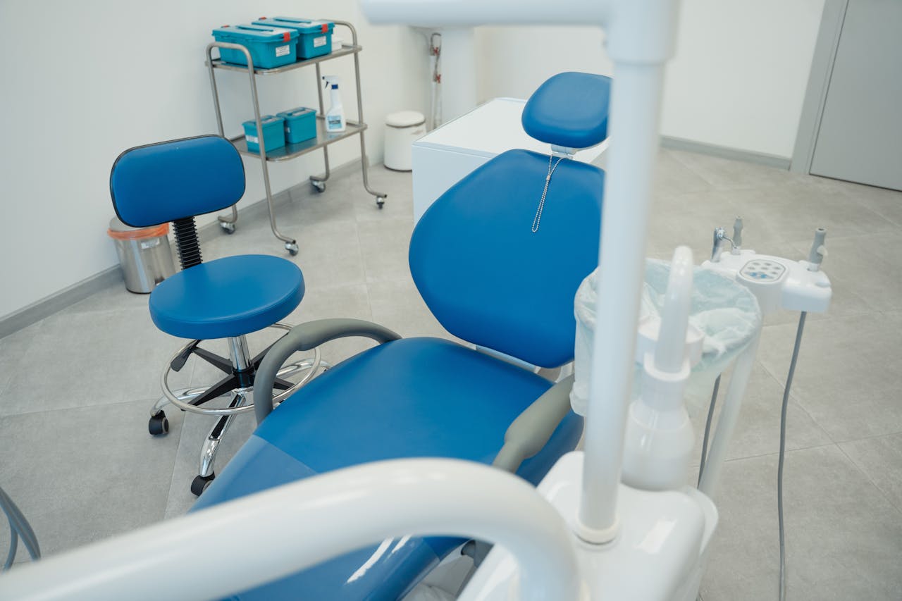 A clean and modern dental clinic featuring blue chairs and essential dental equipment.