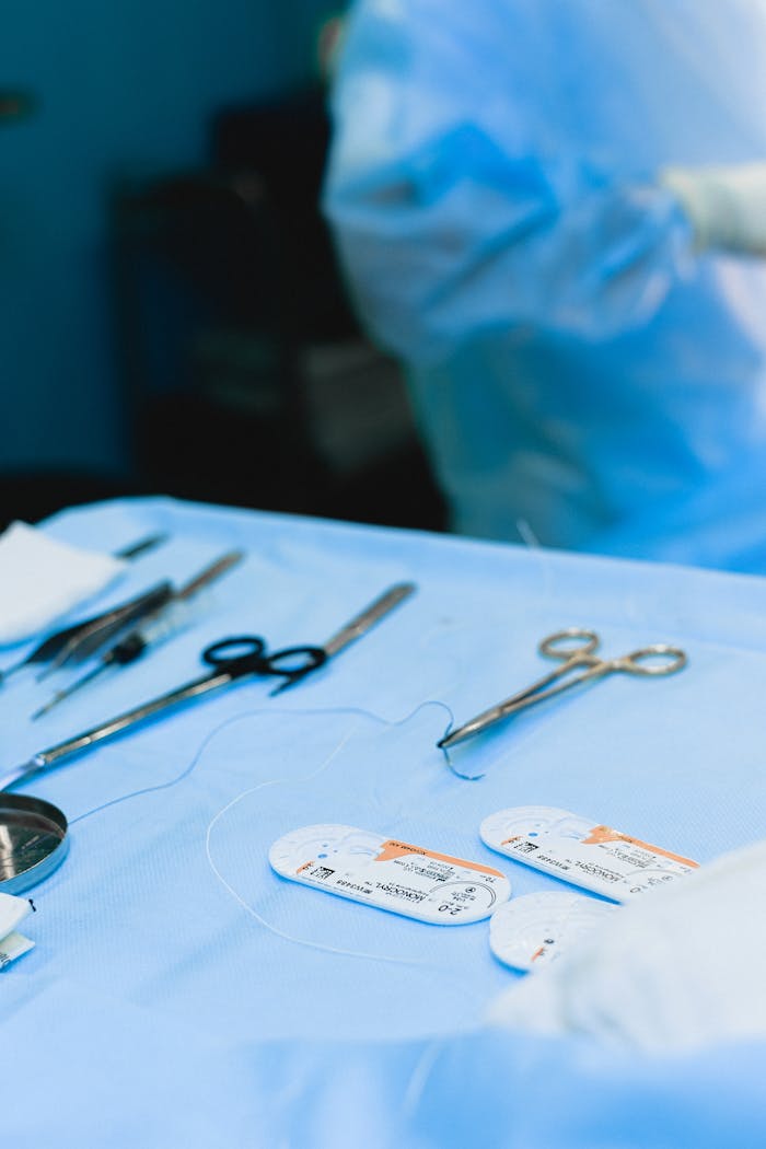 Close-up view of surgical instruments on a sterile table in an operating room.