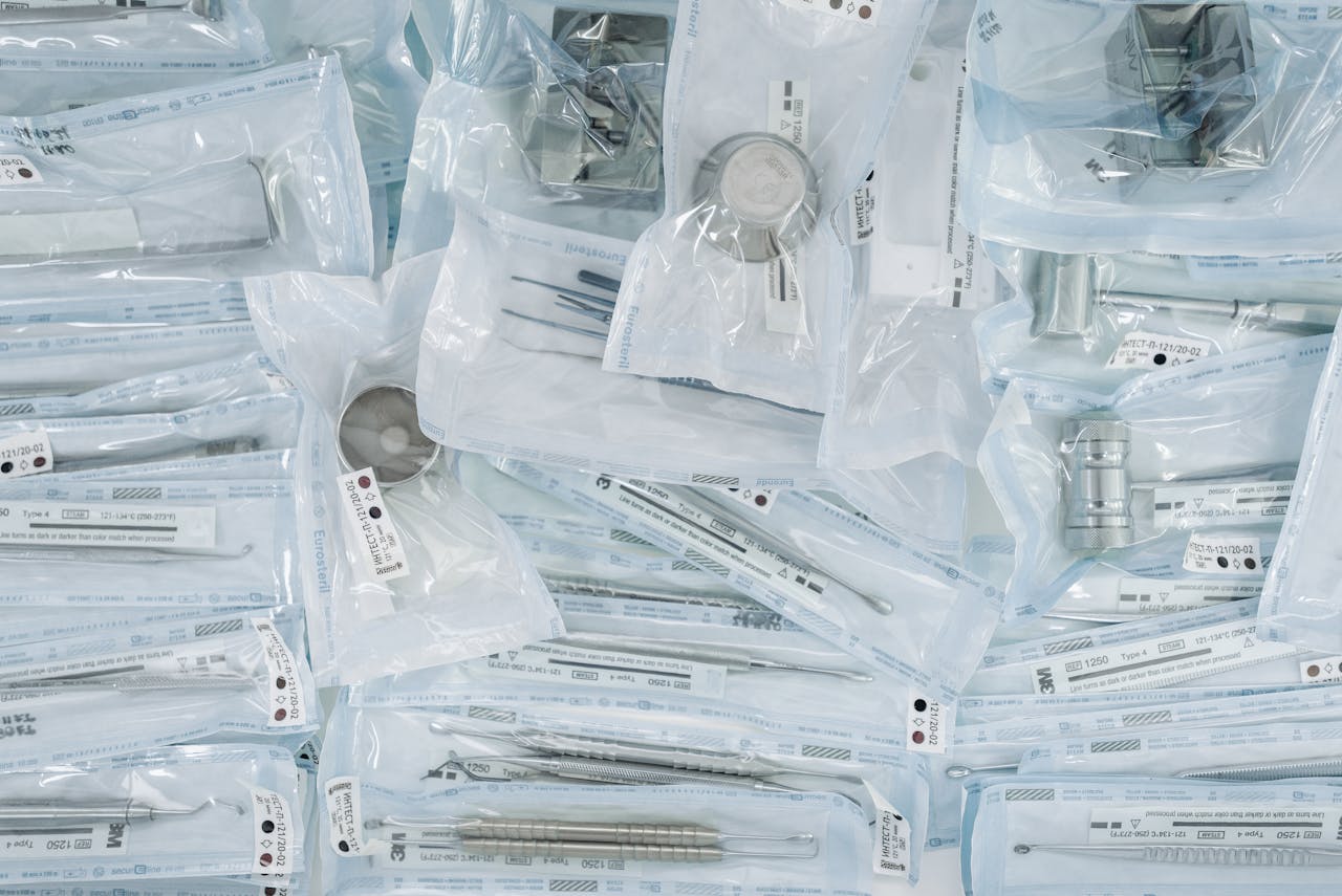 A collection of sterilized dental tools individually sealed in plastic wrap for hygiene.